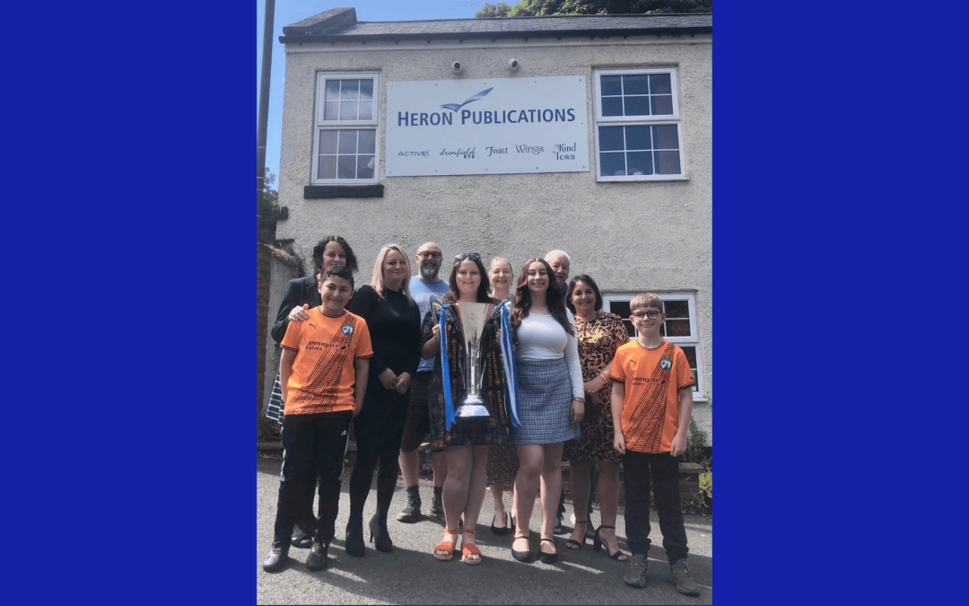 Trophy visits Heron Publications