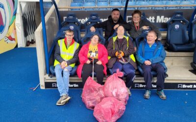 Day centre attendees take part in litter pick at the stadium